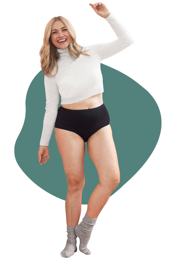 A happy woman wearing a pair of Speax by Thinx hi-waist in the color black.