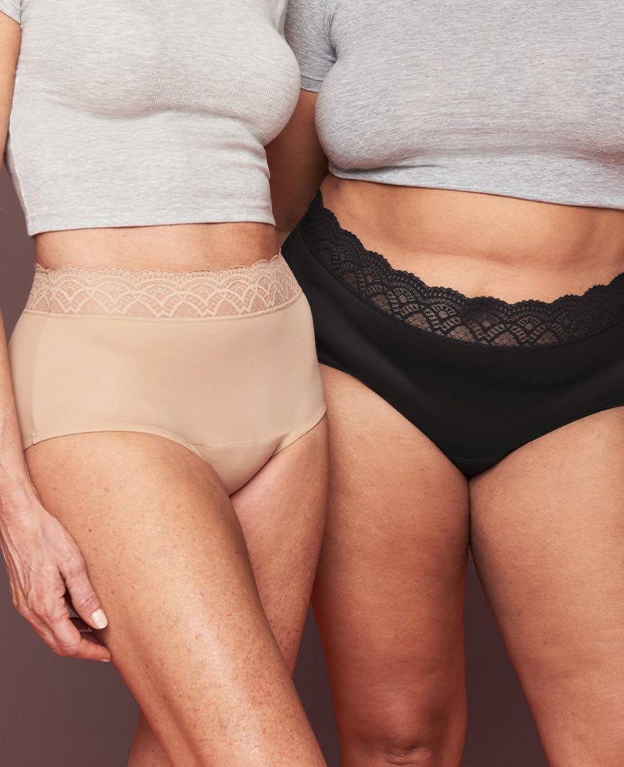 Two models standing side by side shown from the torso down wearing Thinx for All Leaks Lace Hi-Waist underwear for bladder leaks in the colors beige and black