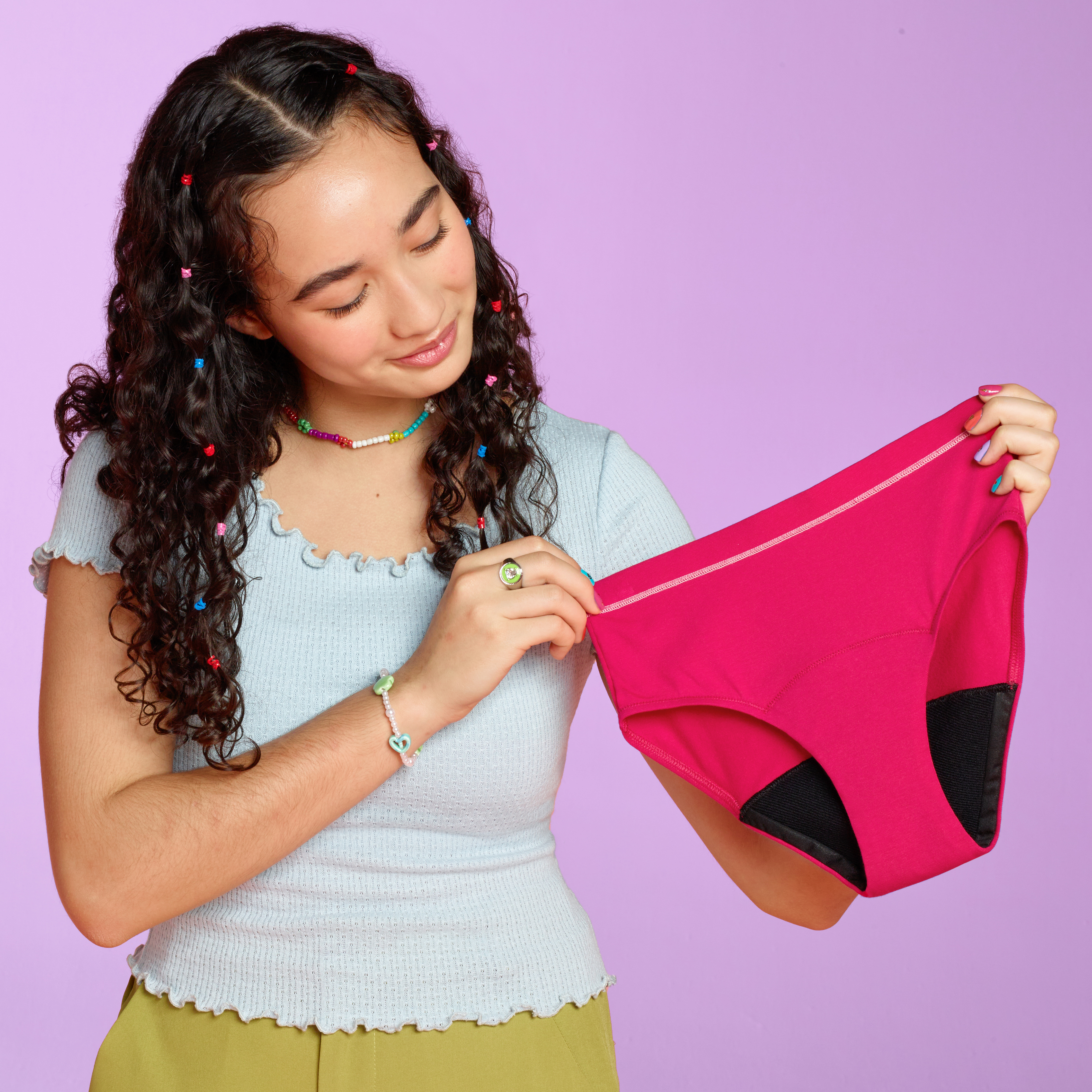 teen holding a pair of the all day brief in hot pink