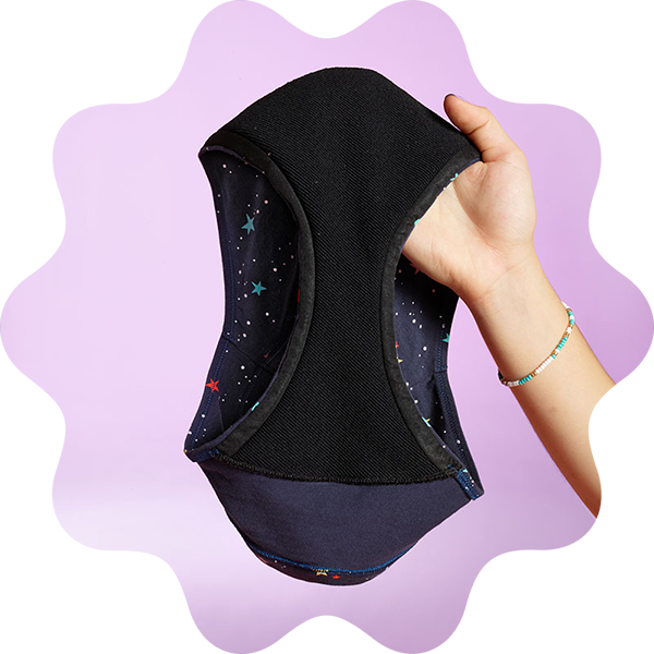Over a purple abstract shape, a hand is holding up a pair of Thinx Teens reusable period underwear with the gusset exposed.